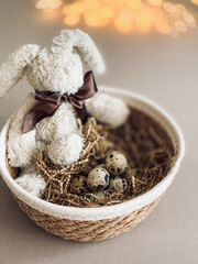 Quail eggs and Easter rabbit in a bowl. Still life aesthetic