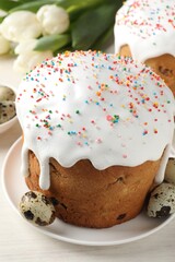 Beautiful Easter cakes, eggs and tulips on white table, closeup