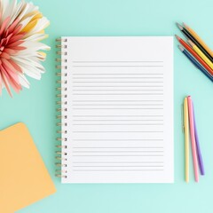 Flat lay of a blank lined notebook, colorful pens and a gerbera daisy on a pastel background. Study, creativity, planning, back to school, stationery, office