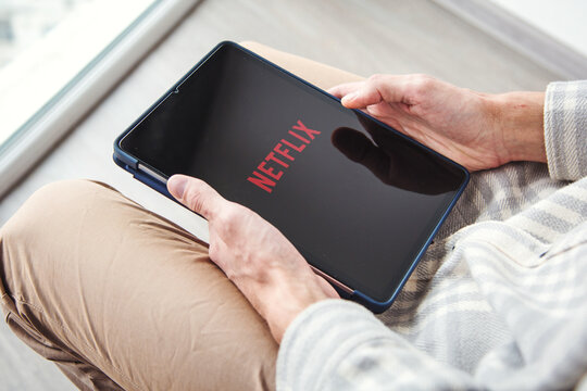 03.03.2025, Batumi, Georgia: person holding a tablet with the Netflix streaming app open. The screen displays the brand's logo on a dark background. Concept of entertainment and digital media