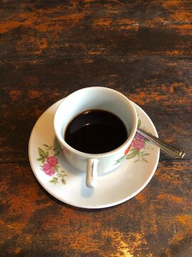 cup of coffee on wooden table