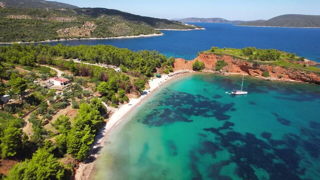 Aerial Cinematic Sequence Part 1: Low Drone Flyover of Kokkinokastro Beach &mdash; Vibrant Turquoise Water with ancored sailing boat and Golden Sands, Alonissos Marine Park Greece