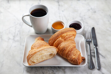 Croissant, Coffee and Jam on Marble Surface. Minimal Breakfast Concept with Croissant, Jam and Coffee. French Style Breakfast on Marble Background.