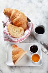 Croissant, Coffee and Jam on Marble Surface. Minimal Breakfast Concept with Croissant, Jam and Coffee. French Style Breakfast on Marble Background.