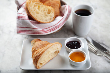 Croissant, Coffee and Jam on Marble Surface. Minimal Breakfast Concept with Croissant, Jam and Coffee. French Style Breakfast on Marble Background.