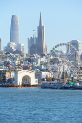 View of San Francisco from a tour boat in the middle of the bay, capturing the city skyline, waterfront, and iconic landmarks. Scenic perspective from the water, ideal for travel, tourism, and maritim