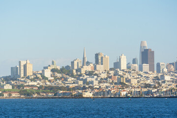 View of San Francisco from a tour boat in the middle of the bay, capturing the city skyline, waterfront, and iconic landmarks. Scenic perspective from the water, ideal for travel, tourism, and maritim