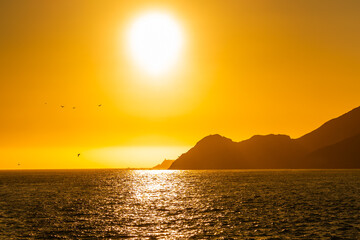 Sunset over the bay area near San Francisco, with warm evening light reflecting on the water. Scenic coastal landscape capturing a peaceful and colorful twilight atmosphere.