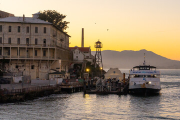 Alcatraz prison at sunset, showcasing the historic island fortress with dramatic evening lighting. Iconic landmark in San Francisco Bay, representing history, tourism, and a mysterious atmosphere