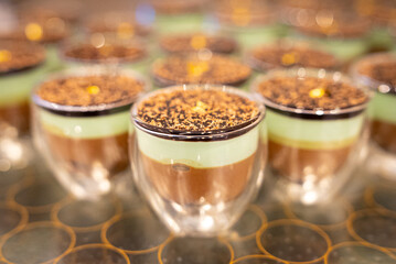 Assorted sweet pastries arranged on a serving tray, featuring a variety of desserts with creamy fillings and decorative toppings. Delicious baked treats presented for dessert, celebration, or caf&eacute; dis