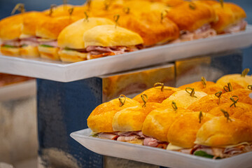 Ham burgers served on a plate, featuring soft buns filled with sliced ham and fresh ingredients. Tasty homemade fast food prepared for lunch or dinner.