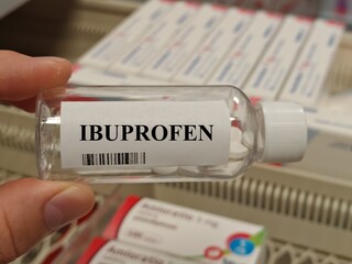 Fototapeta premium Box of ibuprofen tablets placed on a table, over-the-counter anti-inflammatory pain relief medication in daily use.
