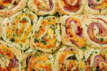 Overheard shot of Savory rolls stuffed with ham , cheese and caramelized onion 