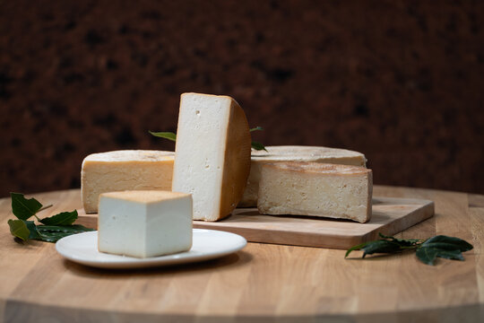 A rustic Spanish cheese board featuring a variety of traditional cheeses, showcasing authentic flavors, artisanal quality, and a cozy gourmet atmosphere