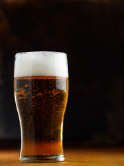 Light beer glass on a wooden table