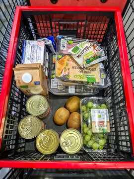 Kiel, Germany - 28. January 2026: Shopping cart full of grocery products at supermarket