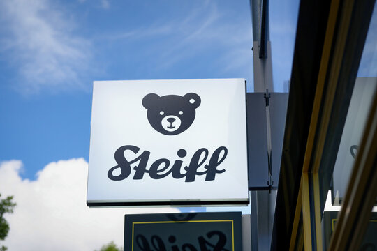 Cologne, Germany July 07 2024: Close-up of the iconic Steiff logo sign featuring the famous teddy bear head. Professional retail branding photography in Cologne, Germany