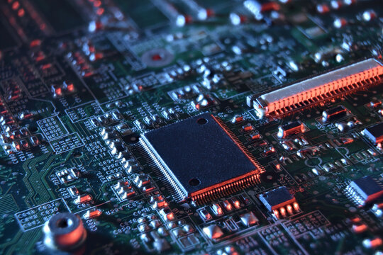 Microchip on Illuminated Circuit Board with blue and red light