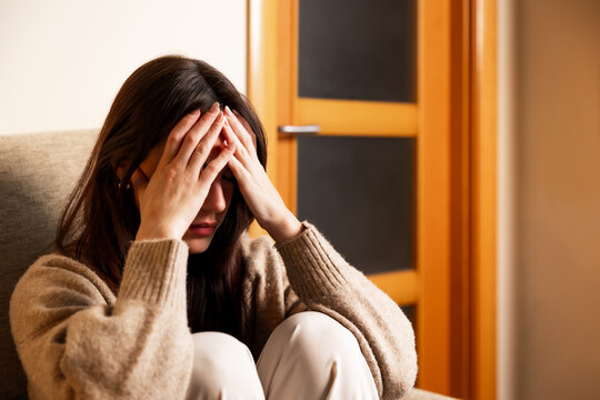 Woman experiencing stress, headache, and mental health issues