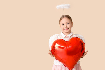 Naklejka premium Cute little girl dressed as cupid with air balloon in shape of heart on beige background. Valentine's Day celebration