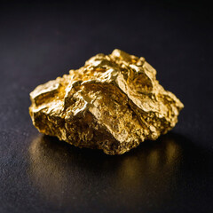 High-value gold nugget. Golden stone on a black background. Symbol of wealth, luxury, and investment. Financial and banking concept. Rising gold prices, commodity market trading worldwide.