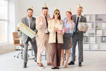 Group of funny business people with Birthday gifts in office