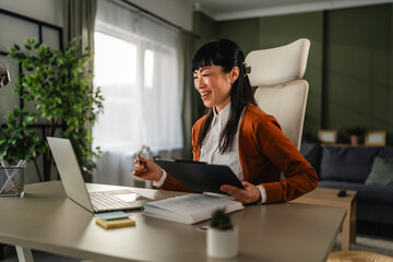 Asian businesswoman experiencing frustration during remote video call meeting