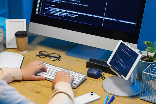 Female programmer working with computer at table in office, closeup