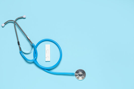 Stethoscope and cba rapid test cassette on blue background with copy space, medical diagnosis, health screening and laboratory examination concept