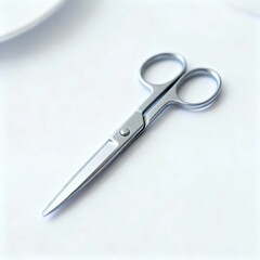 A pair of metallic scissors with pointed blades resting on a white surface