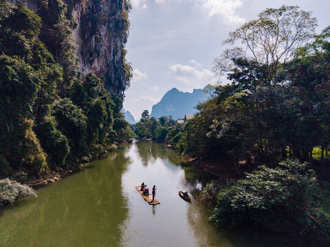 Discover the tranquil beauty of Khao Sok's rivers while canoeing through lush green landscapes