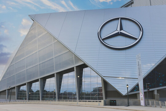 Spectacular hero-angle photo of Mercedes-Benz Stadium in Atlanta, Georgia, captured from the ground with a dramatic upward perspective. The modern stadium&rsquo;s bold architecture stands out 