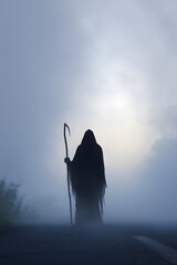 Grim Reaper Silhouette in Eerie Fog