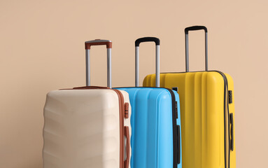 Obraz premium Packed suitcases near beige wall