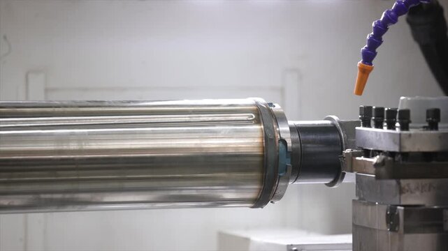 A high-precision CNC lathe machining a large-diameter steel shaft in a modern industrial workshop.