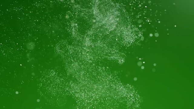 White powder dispersing in green background