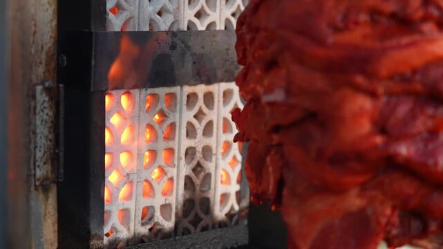 Sizzling Al Pastor Pork Cooking on a Street Food Trompo