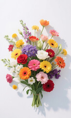 Obraz premium A bright white background decorated with various types of vibrant, colorful flowers, arranged aesthetically to create a fresh, cheerful, and lively atmosphere with balanced lighting.