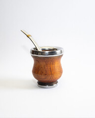 Mate cup with metal rim and metal straw isolated on white background. Traditional South American drink container, minimal product photography with copy space.