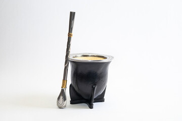 Traditional mate cup made from gourd covered with black leather and smooth metal rim, isolated on white background. Artisan South American drink container, product photo with copy space.