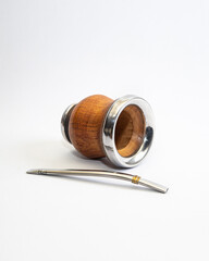 Mate cup with metal rim and metal straw isolated on white background. Traditional South American drink container, minimal product photography with copy space.
