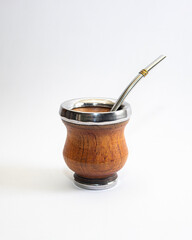 Mate cup with metal rim and metal straw isolated on white background. Traditional South American drink container, minimal product photography with copy space.