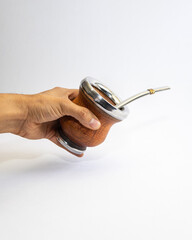 Mate cup with metal rim and metal straw isolated on white background. Traditional South American drink container, minimal product photography with copy space.