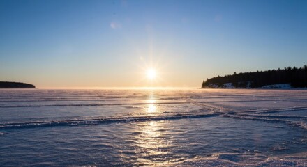 A sunlit, frozen lake with misty horizon, small islands, and cracks in the ice