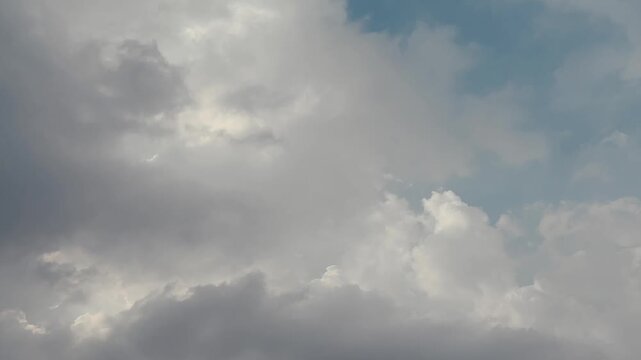 Time-lapse of fluffy white clouds drifting across a deep blue sky, illustrating the beauty of nature and the passage of time.