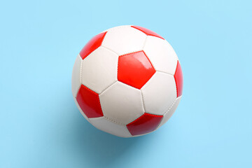 Fototapeta premium Soccer ball on light blue background