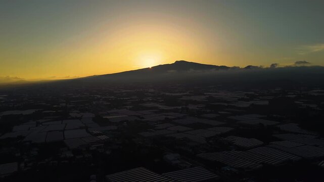 Drone pull back over greenhouses and rural fields on the Jeju island, South Korea