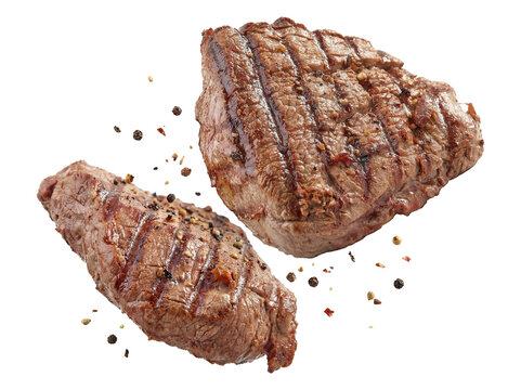 two perfectly grilled beef steaks with peppercorns and grill marks, isolated on a transparent background, ideal for culinary content and advertising.