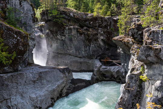 Waterfall spray rising from narrow slot canyon at Nairn Falls.