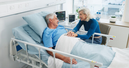 Old couple, smile and holding hands by hospital bed with support, kindness or empathy for recovery....